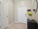 Inviting foyer featuring neutral walls, tile flooring, and a stylish mirror at 14323 Easy Goer St, Ruskin, FL 33573