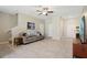 Open-concept living room with a staircase, neutral paint, and access to other rooms at 14323 Easy Goer St, Ruskin, FL 33573