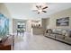 Spacious living room with tile floors, ceiling fan, and an open-concept design at 14323 Easy Goer St, Ruskin, FL 33573