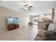Bright living room with open layout to dining and kitchen and neutral tile floors at 14323 Easy Goer St, Ruskin, FL 33573