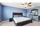 Well-lit main bedroom with king bed, side tables and a ceiling fan at 14323 Easy Goer St, Ruskin, FL 33573