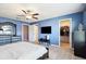 Main bedroom with large television, walk-in closet, and ensuite at 14323 Easy Goer St, Ruskin, FL 33573