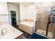 Bathroom featuring double sinks, walk-in shower and separate soaking tub at 1510 Rushgrove Cir, Dover, FL 33527