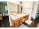 Bathroom vanity featuring double sinks, wood cabinets and large mirrors at 1510 Rushgrove Cir, Dover, FL 33527