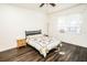 Bright bedroom with dark wood floors, ceiling fan and colorful quilt on bed at 1510 Rushgrove Cir, Dover, FL 33527