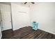 A bedroom featuring dark floors and a double door closet at 1510 Rushgrove Cir, Dover, FL 33527