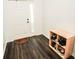 Welcoming foyer featuring wood-look flooring and a convenient shoe storage unit at 1510 Rushgrove Cir, Dover, FL 33527