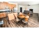 Open concept kitchen with oak cabinets, stainless appliances, and a view to the living room at 1510 Rushgrove Cir, Dover, FL 33527