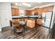 Bright kitchen and dining area with granite counters, island, stainless appliances, and table with chairs at 1510 Rushgrove Cir, Dover, FL 33527