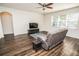 Inviting living area with a soft gray sofa, wood-look floors, and natural light at 1510 Rushgrove Cir, Dover, FL 33527