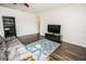 Comfortable living room with a blue rug, TV, and hardwood floors at 1510 Rushgrove Cir, Dover, FL 33527