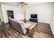 Cozy living room featuring wood floors, a comfortable couch, and a ceiling fan at 1510 Rushgrove Cir, Dover, FL 33527