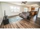 Inviting living area featuring hardwood floors, a comfortable couch, and an adjacent kitchen at 1510 Rushgrove Cir, Dover, FL 33527