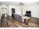 Spacious living room with dark wood floors and comfortable gray seating at 1510 Rushgrove Cir, Dover, FL 33527