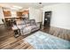 Open-concept living room and kitchen design with hard wood flooring and stainless appliances at 1510 Rushgrove Cir, Dover, FL 33527