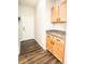 A mudroom with dark wood-look floors and light wood cabinets offers convenient storage space at 1510 Rushgrove Cir, Dover, FL 33527