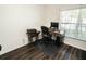 Bright office space with natural light from the large window and wood-look flooring at 1510 Rushgrove Cir, Dover, FL 33527