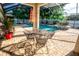 Screened patio featuring outdoor seating area with an in-ground pool and spa at 1510 Rushgrove Cir, Dover, FL 33527