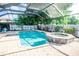 Sparkling pool and spa surrounded by a screen enclosure and lush landscaping at 1510 Rushgrove Cir, Dover, FL 33527