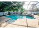 A screened-in pool and spa is surrounded by pavers and landscaping at 1510 Rushgrove Cir, Dover, FL 33527