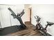 Dedicated workout area with a treadmill and exercise bike on a wood-look floor at 1510 Rushgrove Cir, Dover, FL 33527