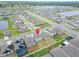 An aerial view of a modern home with green lawns in a Gathering-friendly community with ample sidewalks at 16685 Parker River St, Wimauma, FL 33598