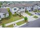 Aerial view of the home showcasing its landscaped yard, driveway, and neighborhood setting at 16685 Parker River St, Wimauma, FL 33598