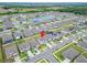 Aerial neighborhood view showcasing the property with its well-maintained landscaping, among many homes at 16685 Parker River St, Wimauma, FL 33598