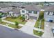 Aerial view of the property featuring a manicured lawn, long driveway, and a two-car garage at 16685 Parker River St, Wimauma, FL 33598