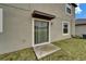 Back door of the home with sliding glass door and concrete slab at 16685 Parker River St, Wimauma, FL 33598