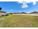 Expansive backyard with lush green grass and white fence at 16685 Parker River St, Wimauma, FL 33598