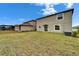 Spacious backyard featuring a lawn and rear exterior of the home at 16685 Parker River St, Wimauma, FL 33598