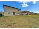 Spacious backyard showcasing a well-maintained lawn and exterior of home at 16685 Parker River St, Wimauma, FL 33598