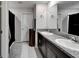 Well-lit bathroom features double sinks, granite counters, and ample storage space at 16685 Parker River St, Wimauma, FL 33598