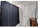 This bathroom offers a dark shower curtain, towel rack, and stylish vanity for extra storage at 16685 Parker River St, Wimauma, FL 33598