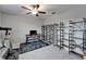 Bedroom featuring a ceiling fan, desk, telescope, and decorative shelving at 16685 Parker River St, Wimauma, FL 33598