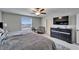 Relaxing bedroom showcases a big window for natural light, with a stylish dresser and two chairs at 16685 Parker River St, Wimauma, FL 33598