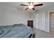Bedroom offering a ceiling fan, double door closet, and dresser at 16685 Parker River St, Wimauma, FL 33598