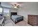 Bedroom with carpet floors, ceiling fan, dresser, and window at 16685 Parker River St, Wimauma, FL 33598