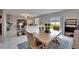Open dining and living room space featuring a neutral color palette and sliding glass doors to the backyard at 16685 Parker River St, Wimauma, FL 33598