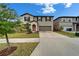 Inviting two-story home features a tidy front yard, cozy entrance, and convenient two-car garage at 16685 Parker River St, Wimauma, FL 33598