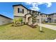 Charming two-story home with a well-manicured lawn, two-car garage, and inviting entrance at 16685 Parker River St, Wimauma, FL 33598