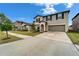 Charming two-story home with a well-manicured lawn, two-car garage, and inviting entrance at 16685 Parker River St, Wimauma, FL 33598