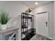 Inviting foyer with neutral tones, open space, hall tree and a glimpse of the front door at 16685 Parker River St, Wimauma, FL 33598