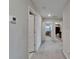 Bright hallway with neutral carpet, multiple doors, and natural light from nearby windows at 16685 Parker River St, Wimauma, FL 33598