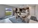 Open-concept kitchen featuring dark wood cabinetry, stainless steel appliances, and backyard access at 16685 Parker River St, Wimauma, FL 33598