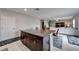 Spacious living area with tile flooring, neutral walls, and direct access to the kitchen area at 16685 Parker River St, Wimauma, FL 33598