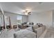 Living room area showcasing a large gray sectional sofa with a ceiling fan, window and modern decor at 16685 Parker River St, Wimauma, FL 33598