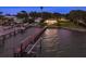 Aerial view showcasing a waterfront property with a long dock and serene water views at twilight at 1748 Sunset Dr, Clearwater, FL 33755