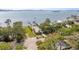 Scenic aerial view of waterfront home with private dock and lush green lawns at 1748 Sunset Dr, Clearwater, FL 33755